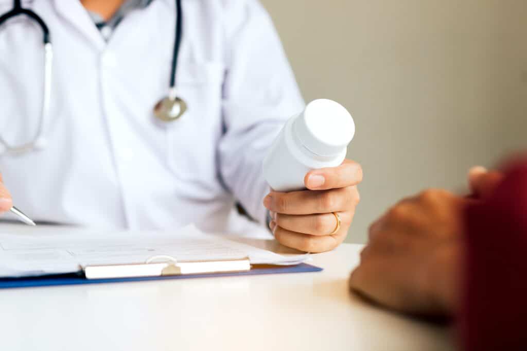 Doctor consulting to patient and talking about medicine.